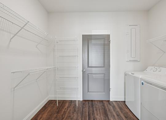 A white laundry room with a washer and dryer.