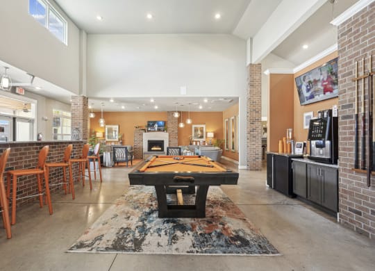 a game room with a pool table and a bar