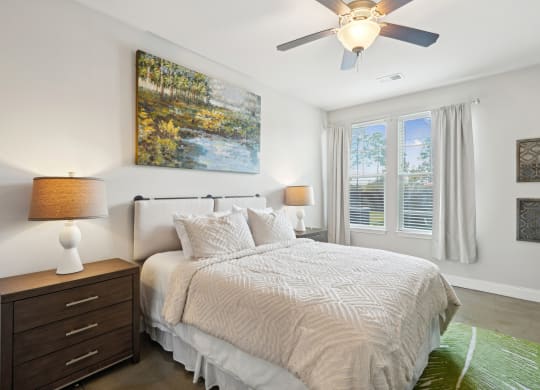 a bedroom with a bed and a ceiling fan