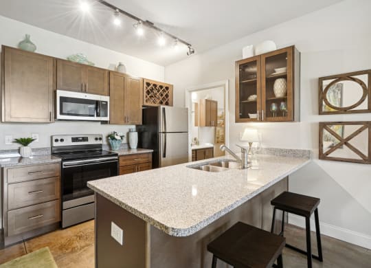 a kitchen with granite counter tops and stainless steel appliances