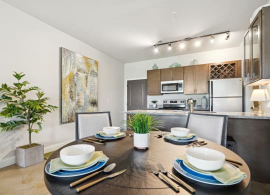 a kitchen and dining room with a table and chairs