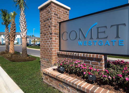 A sign for Comet Westgate is displayed on a brick pillar.
