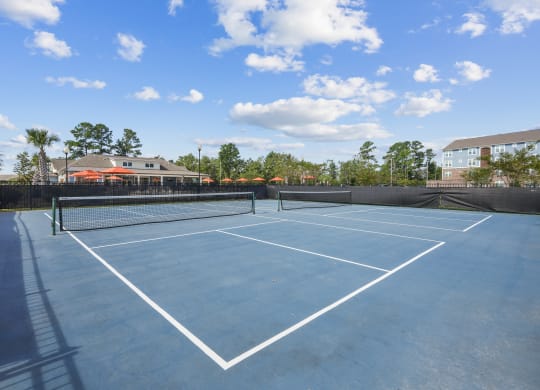 enjoy a game of tennis on the tennis court at the enclave at legend woods apartments