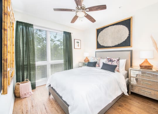 a bedroom with a large bed and a ceiling fan
