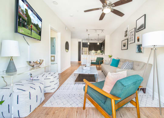 a living room with a couch and a ceiling fan