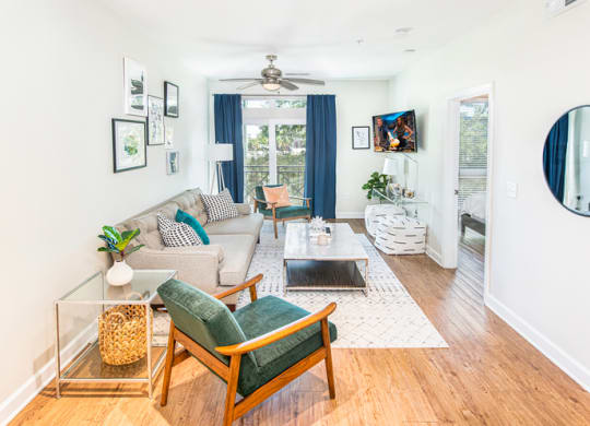 a living room with furniture and a ceiling fan