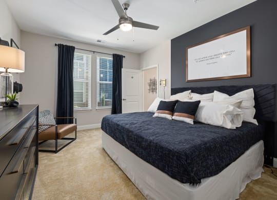 a bedroom with a bed and a ceiling fan