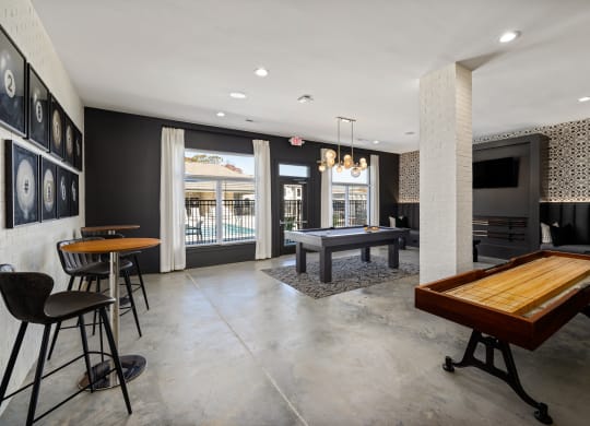 a game room with a pool table and a bar