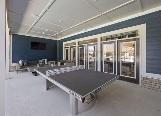 a ping pong table in the exterior of clubhouse