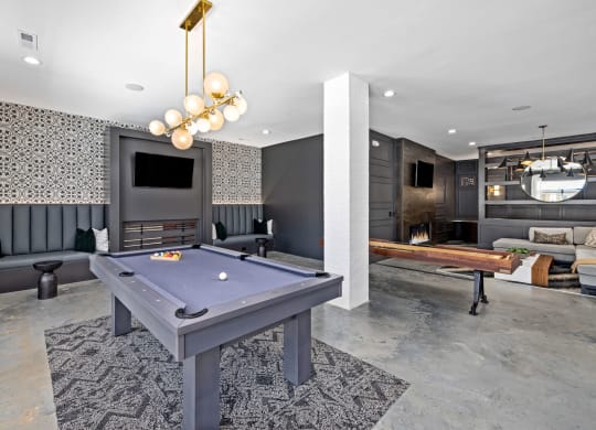 a pool table in resident lounge with a television