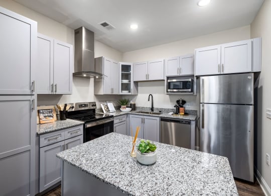 a kitchen with stainless steel appliances and granite counter tops