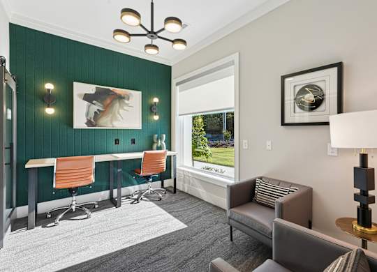 A room with a green wall and a window overlooking a green field.