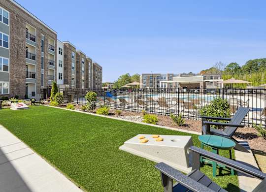 A sunny day at a residential complex with a pool and a picnic table.