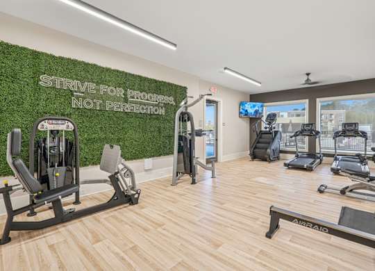 A gym with a green wall that says