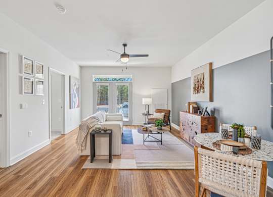 A living room with a white ceiling and a fan.