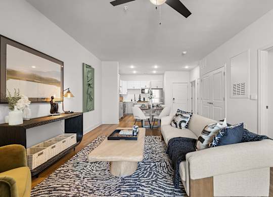 A modern living room with a white sofa and a coffee table.