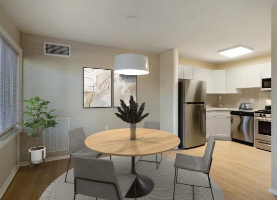 a dining room with a table and chairs and a kitchen with stainless steel appliances