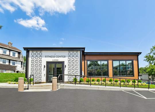 A fitness center with a black and white facade and a glass window.