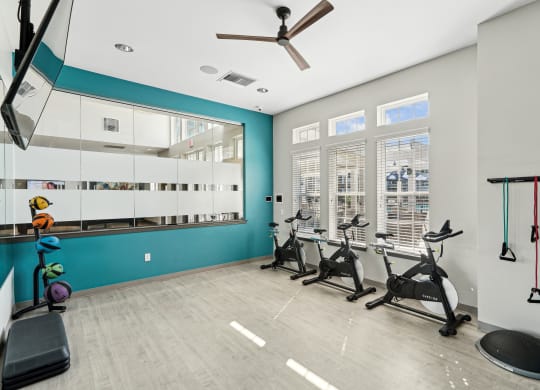 the gym with treadmills and weights at the belgard apartments