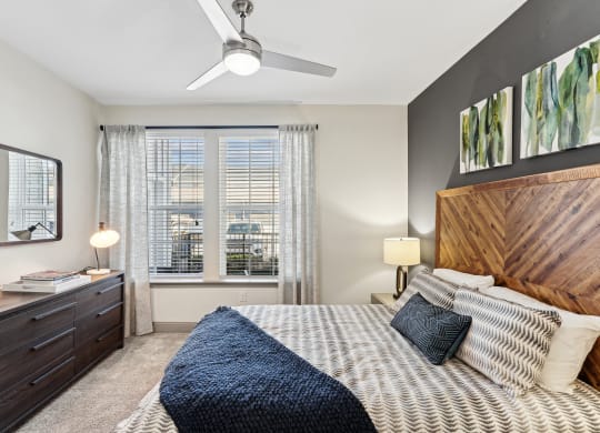 a bedroom with a large bed and a ceiling fan