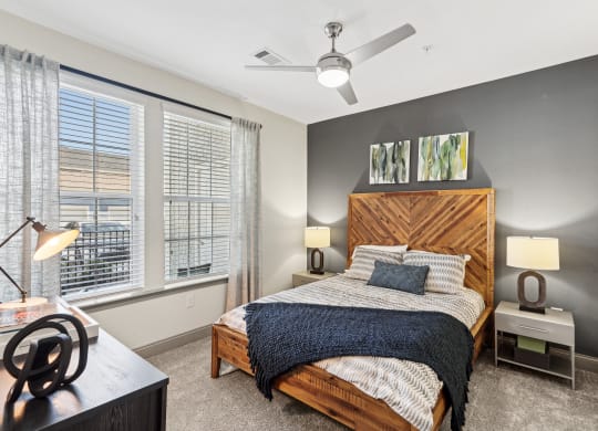 a bedroom with a bed and a ceiling fan