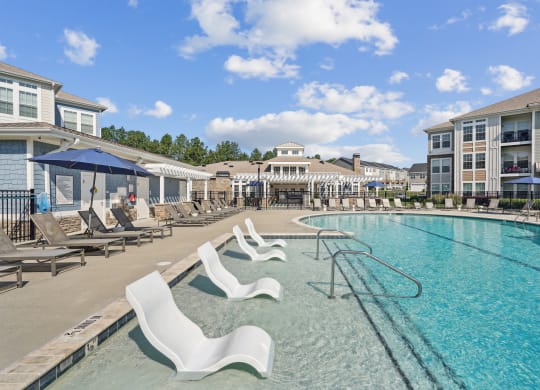 our resort style swimming pool is next to our building with lounge chairs