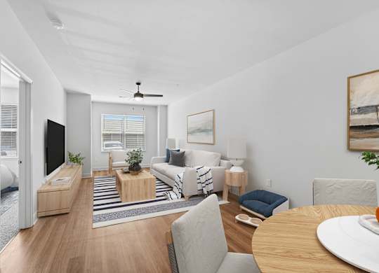 A living room with a sofa set, a coffee table, and a television.