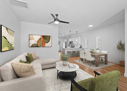 A living room with a beige couch, a green chair, and a coffee table.