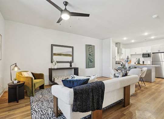 A modern living room with a white sofa and a zebra print rug.
