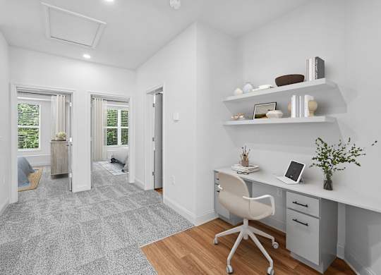 A white room with a desk and a chair.