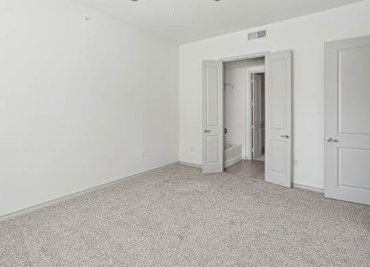 A room with a carpeted floor and white walls.