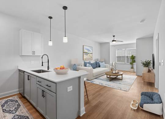 A modern kitchen with a white countertop and grey cabinets.