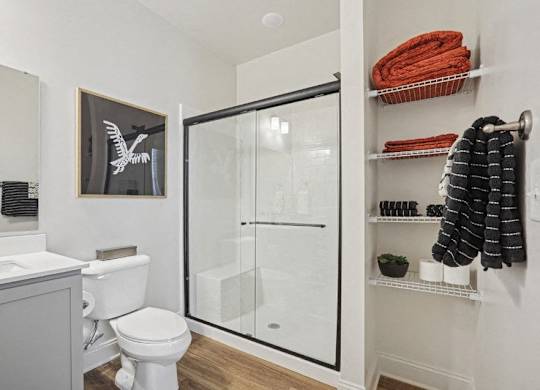 A white toilet sits next to a white sink in a bathroom.