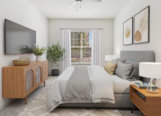 A bedroom with a bed, nightstand, and a television on the wall.