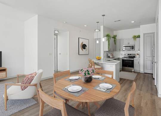 A modern dining room with a wooden table set for two.