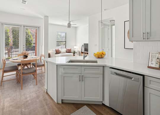 A kitchen with a table and chairs by a window.