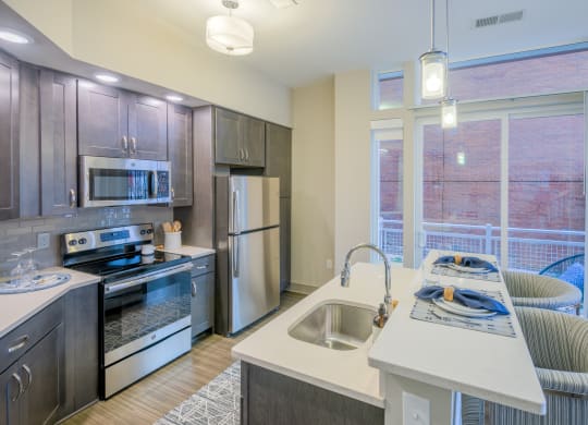 a kitchen with stainless steel appliances and a large window
