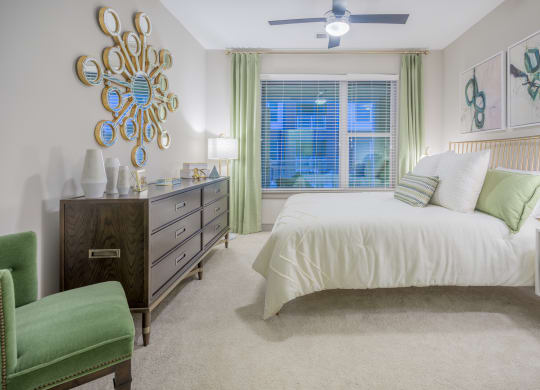 a bedroom with a bed and a dresser and a window
