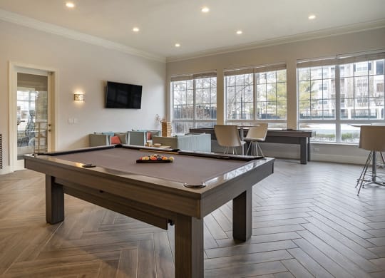 a games room with a pool table and a tv