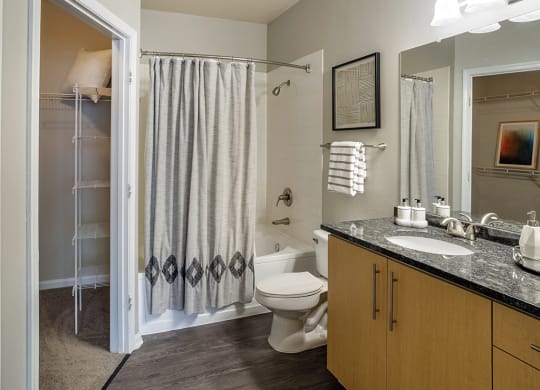 a bathroom with a shower and a toilet and a sink