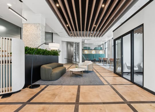 a lobby with a couch and chairs and a reception desk