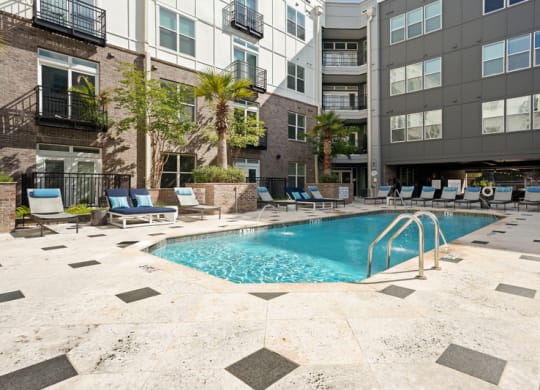 a swimming pool in front of an apartment building