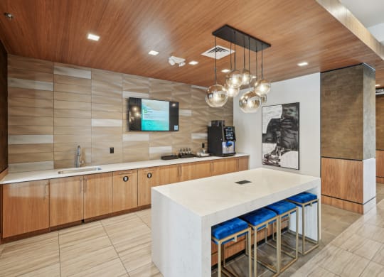 a large kitchen with a white counter top and a sink