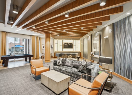 a living room with a couch and chairs and a table