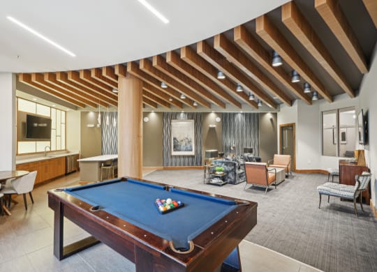 a clubhouse with a pool table and a living room