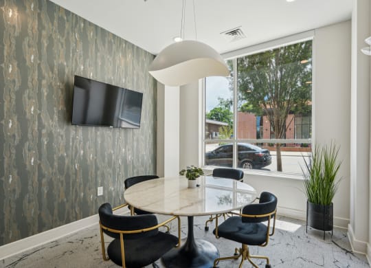a dining room with a large window and a table and chairs