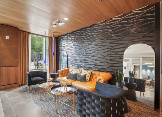 the lobby of a hotel with a couch and tables