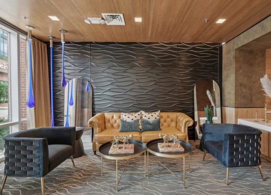 a living room with a couch and chairs and a wall with a wavy design