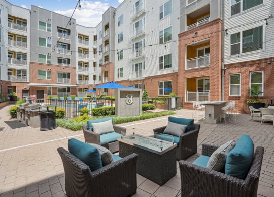 an outdoor patio with furniture and an apartment building