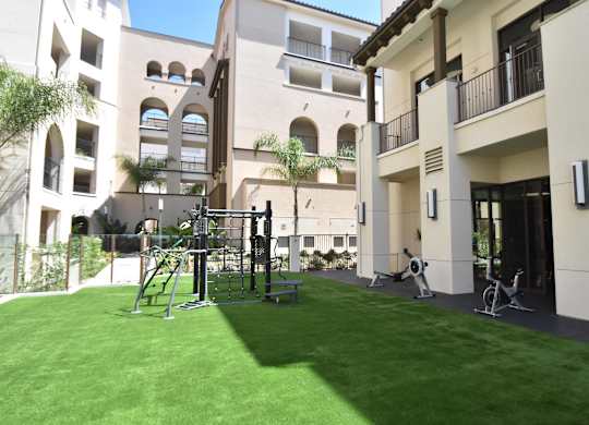 Outdoor fitness area with artificial turf courtyard at Casa Mira View Apartments, San Diego